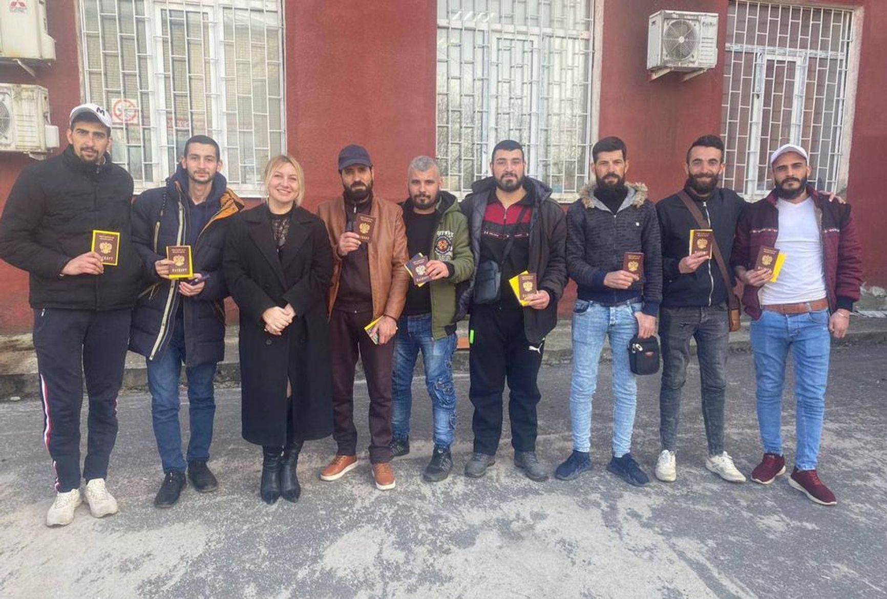 Wahid Mursala al-Shibli receives his Russian passport (third from right)