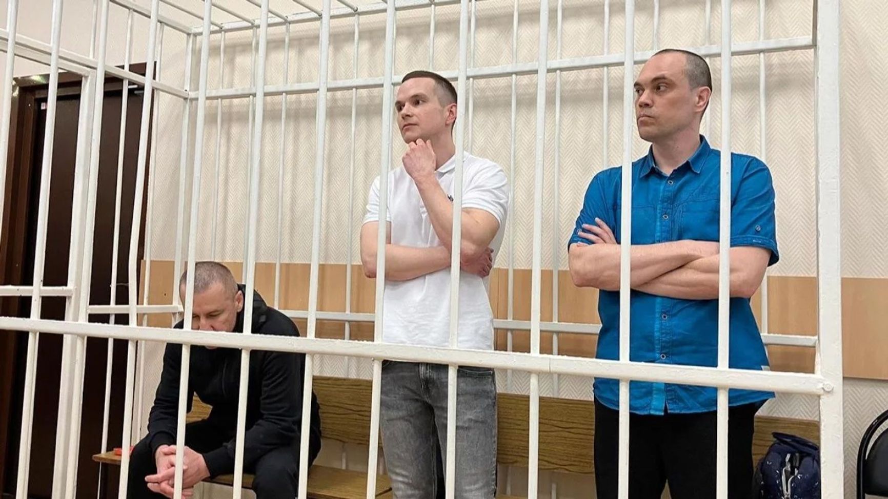 Alexei Navalny's lawyers Igor Sergunin, Alexei Liptser, and Vadim Kobzev in a courtroom holding cell